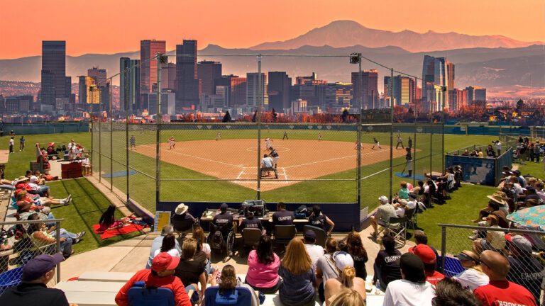 sports parents looking on at softball game played at coolest stadium in the world?